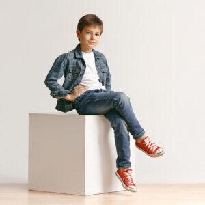 portrait-cute-little-kid-boy-stylish-jeans-clothes-looking-camera-against-white-studio-wall-kids-fashion-concept